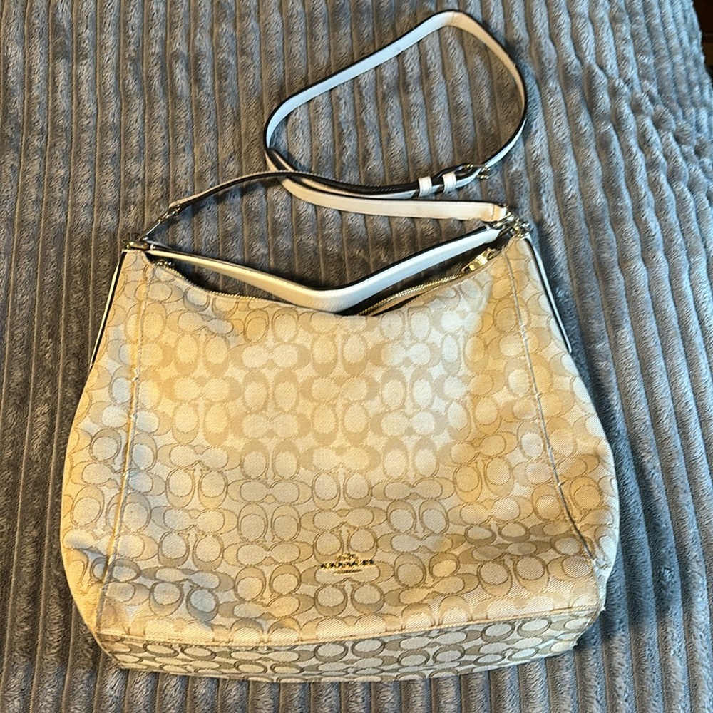 Coach purse, carry two ways.Two pouches and zip side pocket inside.